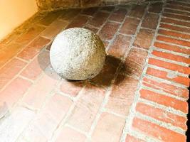 Old large stone ancient medieval iron martial round spherical cannonball photo