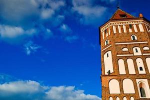 Tall steeples and towers, the roof of an old, ancient medieval baroque castle, a renaissance, Gothic in the center of Europe against a blue sky photo