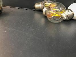 View of white LED energy saving lamps lie on a black background photo