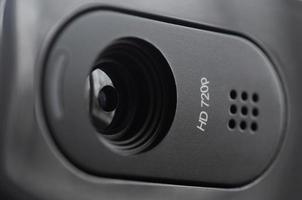 A modern web camera is installed on the body of a flat screen monitor. Device for video communication and recording of high quality video photo