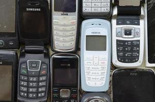 KHARKOV, UKRAINE - DECEMBER 9, 2020 Some old used outdated mobile phones. Recycling electronics in the market cheap photo