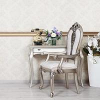 A fragment of a retro interior with a chair and a desk on which is located a telephone and a vase of flowers photo