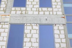 Fragment of an unfinished structure of a multi-storey building made of large concrete bricks photo