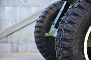 A close-up wheels of a portable weapon of the Soviet Union of World War II, painted in a dark green photo