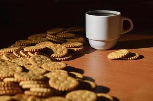 Small coffee cup and salted cracker photo