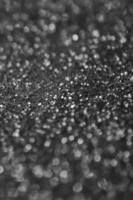 Silver decorative sequins. Background image with shiny bokeh lights from small elements photo