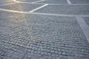 Fragment of the street square, folded out of a gray square paving stone photo