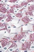 Close up background photo Amount of Five hundred notes of European Union Currency. Many pink 500 euro banknotes are adjacent. Symbolic texture photo for wealth