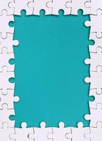 Framing in the form of a rectangle, made of a white jigsaw puzzle around the blue space photo