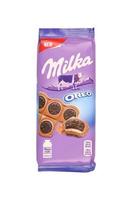 KHARKOV, UKRAINE - DECEMBER 8, 2020 Purple Milka chocolate on white. Milka is a Swiss brand of chocolate confection manufactured internationally by company Mondelez International photo