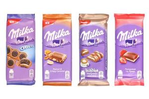 KHARKOV, UKRAINE - DECEMBER 8, 2020 Purple Milka chocolate bars on white. Milka is a Swiss brand of chocolate confection manufactured internationally by company Mondelez International photo