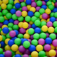 Swimming pool for fun and jumping in colored plastic balls photo