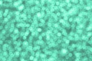 A huge amount of decorative sequins. Background image with shiny bokeh lights from small elements photo