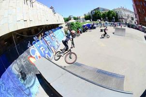 KHARKIV, UKRAINE - 27 MAY, 2018 Freestyle BMX riders in a skatepark during the annual festival of street cultures photo