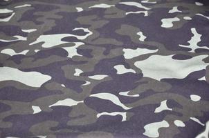 Texture of fabric with a camouflage painted in colors of the marsh. Army background image photo