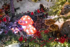 toy bird on the Christmas tree, toys on a snowy christmas tree photo