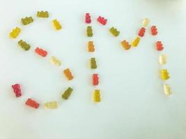 letter from multi-colored gummy bears. Letter S and M made from gelatinous candies. an edible word. vitamin letter, delicious sweetness. natural sweets made from juices and nectars photo