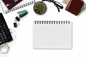 White office desk with calculator, wallet, and supplies. Top view with copy space photo