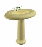 Cream colored washbasin or sink on a stand, with golden faucet. photo