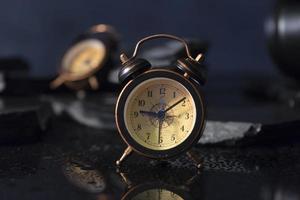 Alarm clocks and reflection on the table photo