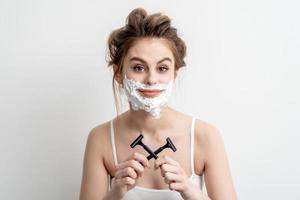 Woman with shaving foam on her face photo