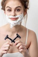 Woman with shaving foam on her face photo