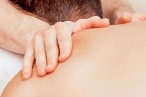 Young man receiving back massage. photo