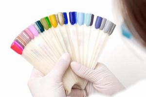 Manicurist holding nail color samples. photo