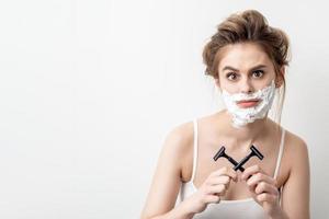 Woman with shaving foam on her face photo