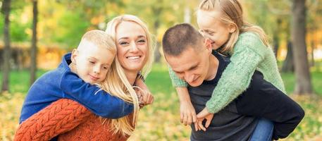 Portrait of young family in autumn park photo