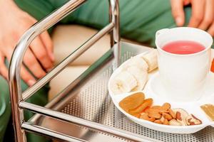 Tea drinking with dried fruits between two male doctors and a woman. photo