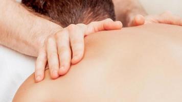 Young man receiving back massage. photo