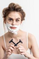 Woman with shaving foam on her face photo