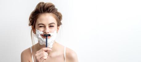 Woman shaving her face by razor photo