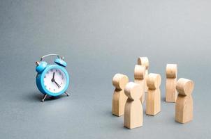 A crowd of people looks at the clock. Attention people are chained to the clock. Waiting for events over time. Relocation hours. Work day and hourly pay. Limited offer, time limit. Selective focus photo