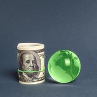 Roll of dollars and green planet earth globe. International money transfers, attraction of investments. Global financial system. World trade and economic relations ties. Business industry. minimalism photo