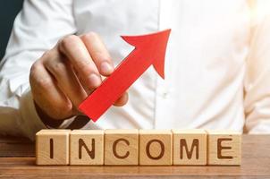 A man holds a red arrow over the words profit. Development of approaches and optimization of business processes to improve efficiency and profitability. Cost reduction, Financial advisor photo