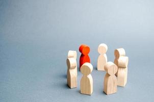 People stand in a circle on a gray background. Communication. Business team, teamwork, team spirit. Wooden figures of people. A circle of people. discussion, cooperation, cooperation. Selective focus photo