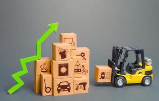 Forklift next to boxes and green up arrow. Logistics, transport infrastructure. Growth of online distribution of goods, increased delivery. E-commerce. High demand and sales. Economic recovery. photo