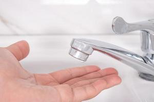 Closeup of hands in the sink to clean hands with soap. Anti virus concept. photo