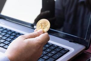 Laptop with cash and bitcoin photo