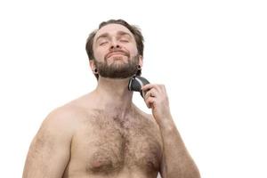 A man shaves himself against a white background photo