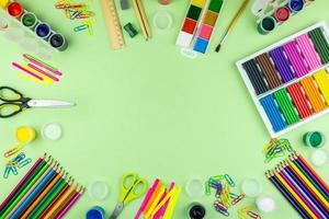 School supplies on a green background photo