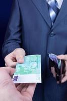Businessman gives money his partner photo