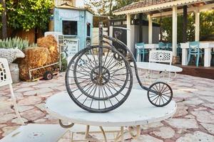 Model of an old tricycle made of metal photo