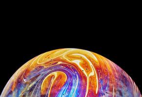 Virtual reality space with abstract multicolor psychedelic planet. Closeup Soap bubble like an alien planet on black background photo