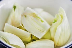 Onion sliced in bowl, ready for cooking photo