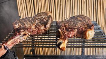 Lamb ribs are cooked on the grill for serving in catering photo