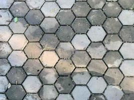 Hexagon-patterned concrete floor with sunlight shining from the middle to the edge of the picture photo