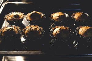 Delicious fluffy muffins in the hot oven photo